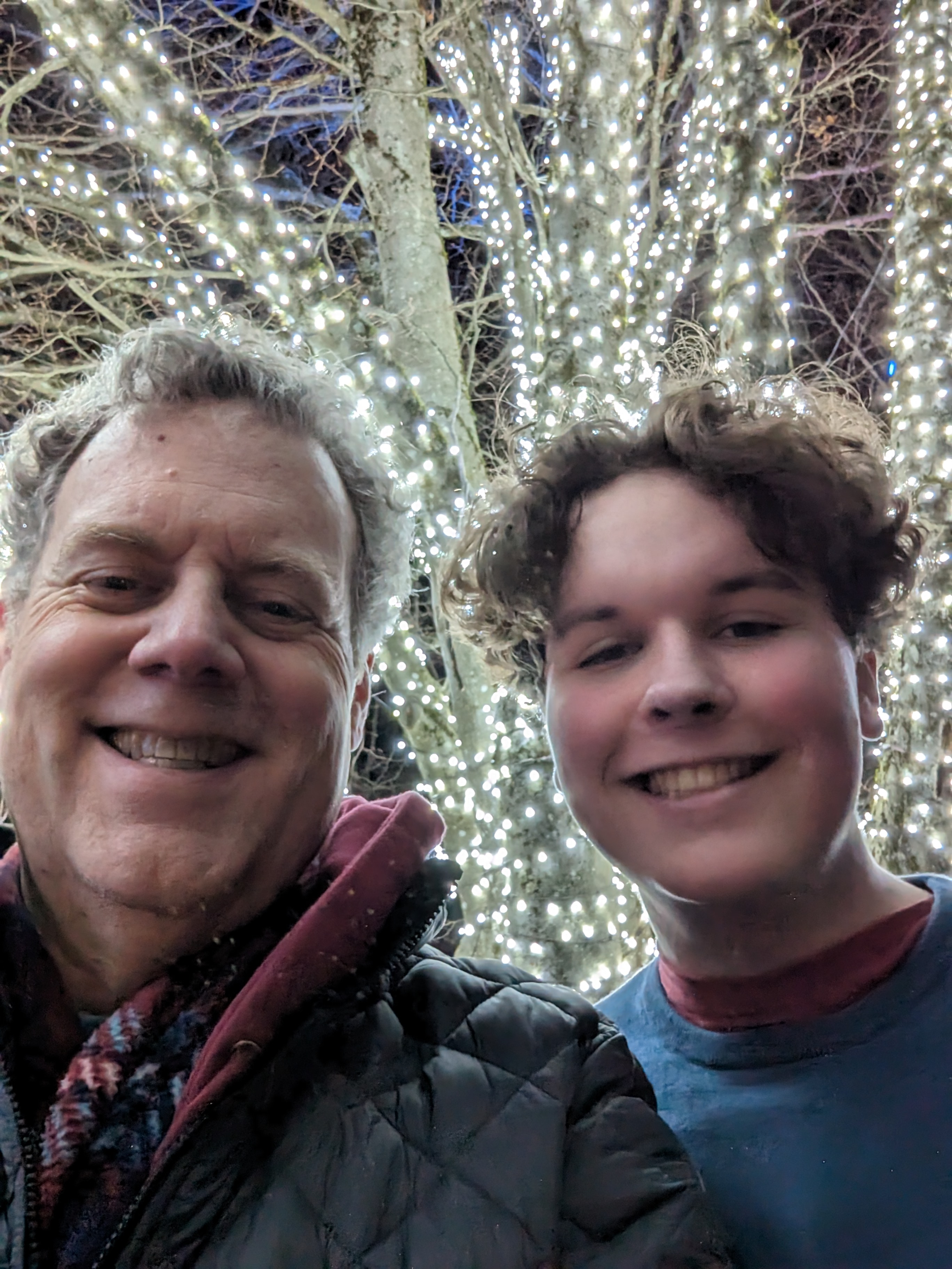 Richie and Xavier under holiday lights